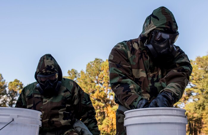 Airmen simulate decontamination during a chemical, biological, radiological, nuclear and high-yield explosives training course Dec. 3, 2014, at Joint Base Charleston, S.C. After Air Force Basic military training, active-duty Airmen are required to go through CBRNE refresher training every two years. (U.S. Air Force photo/Senior Airman Marianique Santos)