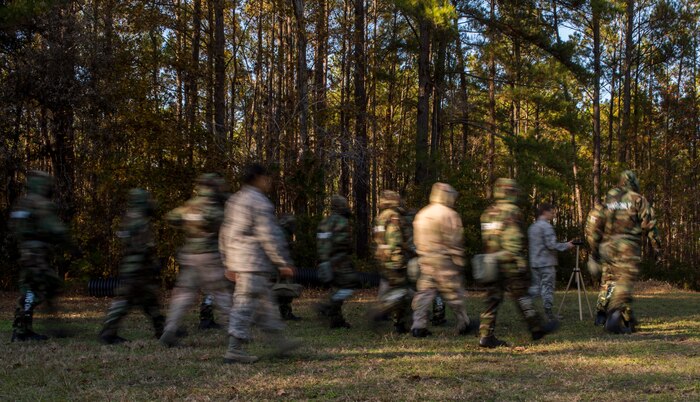 Chemical, biological, radiological, nuclear and high-yield explosives training instructors and students walk toward a liquid detection point to check for simulated contamination during a CBRNE refresher course Dec. 3, 2014, at Joint Base Charleston, S.C. After Air Force Basic military training, active-duty Airmen are required to go through CBRNE refresher training every two years. (U.S. Air Force photo/Senior Airman Marianique Santos)