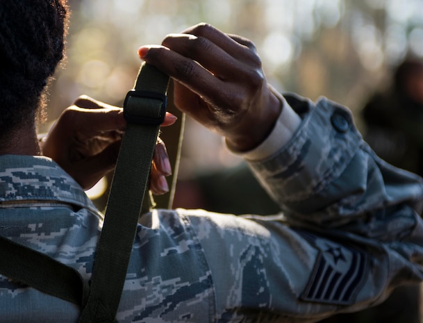 Technical Sgt. Miranda Green, 628th Air Base Wing Equal Opportunity NCOIC, tightens the straps on her chemical suit during a chemical, biological, radiological, nuclear and high-yield explosives training course Dec. 3, 2014, at Joint Base Charleston, S.C. After Air Force Basic military training, active-duty Airmen are required to go through CBRNE refresher training every two years. (U.S. Air Force photo/Senior Airman Marianique Santos)