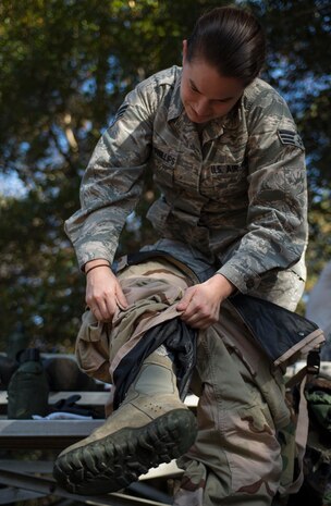 Senior Airman Gloria Davis-Phillips, 437th Maintenance Group maintenance data analyst, puts on her chemical suit during a chemical, biological, radiological, nuclear and high-yield explosives training course Dec. 3, 2014, at Joint Base Charleston, S.C. After Air Force Basic military training, active-duty Airmen are required to go through CBRNE refresher training every two years. (U.S. Air Force photo/Senior Airman Marianique Santos)