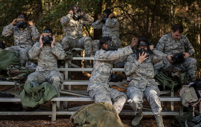 Airmen adjust their gas masks during a chemical, biological, radiological, nuclear and high-yield explosives training course Dec. 3, 2014, at Joint Base Charleston, S.C. After Air Force Basic military training, active-duty Airmen are required to go through CBRNE refresher training every two years. (U.S. Air Force photo/Senior Airman Marianique Santos)