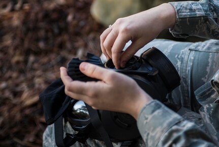 Senior Airman Gloria Davis-Phillips, 437th Maintenance Group maintenance data analyst, checks the seals on her gas mask during a chemical, biological, radiological, nuclear and high-yield explosives training course Dec. 3, 2014, at Joint Base Charleston, S.C. After Air Force Basic military training, active-duty Airmen are required to go through CBRNE refresher training every two years. (U.S. Air Force photo/Senior Airman Marianique Santos)