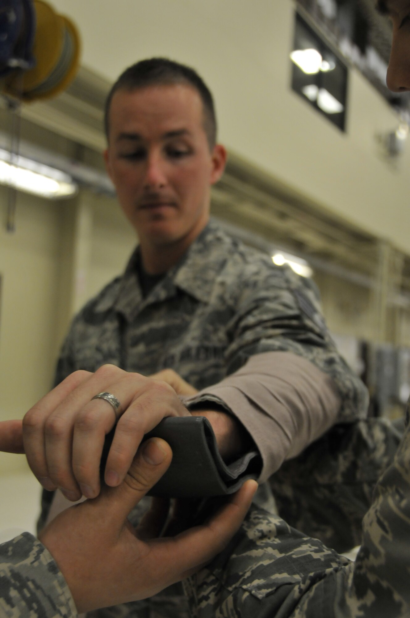 Staff Sgt. Eric Green holds out his arm while members of the 188th Wing practice immobilizing it during an expeditionary skills rodeo held at Ebbing Air National Guard Base, Fort Smith, Ark., Dec. 7. The event was designed to refresh the members’ chemical survival and self-aid buddy care skills. Green is assigned to the 188th Communications Flight. (U.S. Air National Guard photo by Staff Sgt. John Suleski/Released)