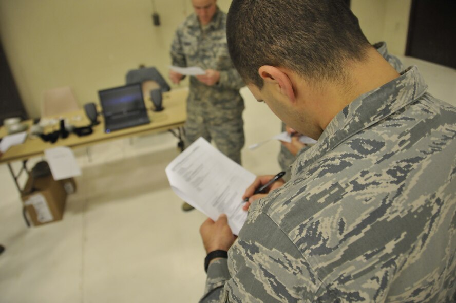 Members of the 188th Wing read about different ways to stop external bleeding at a an expeditionary skills rodeo held at Ebbing Air National Guard Base, Fort Smith, Ark., Dec. 7. The event was designed to refresh the members’ chemical survival and self-aid buddy care skills. (U.S. Air National Guard photo by Staff Sgt. John Suleski/Released)