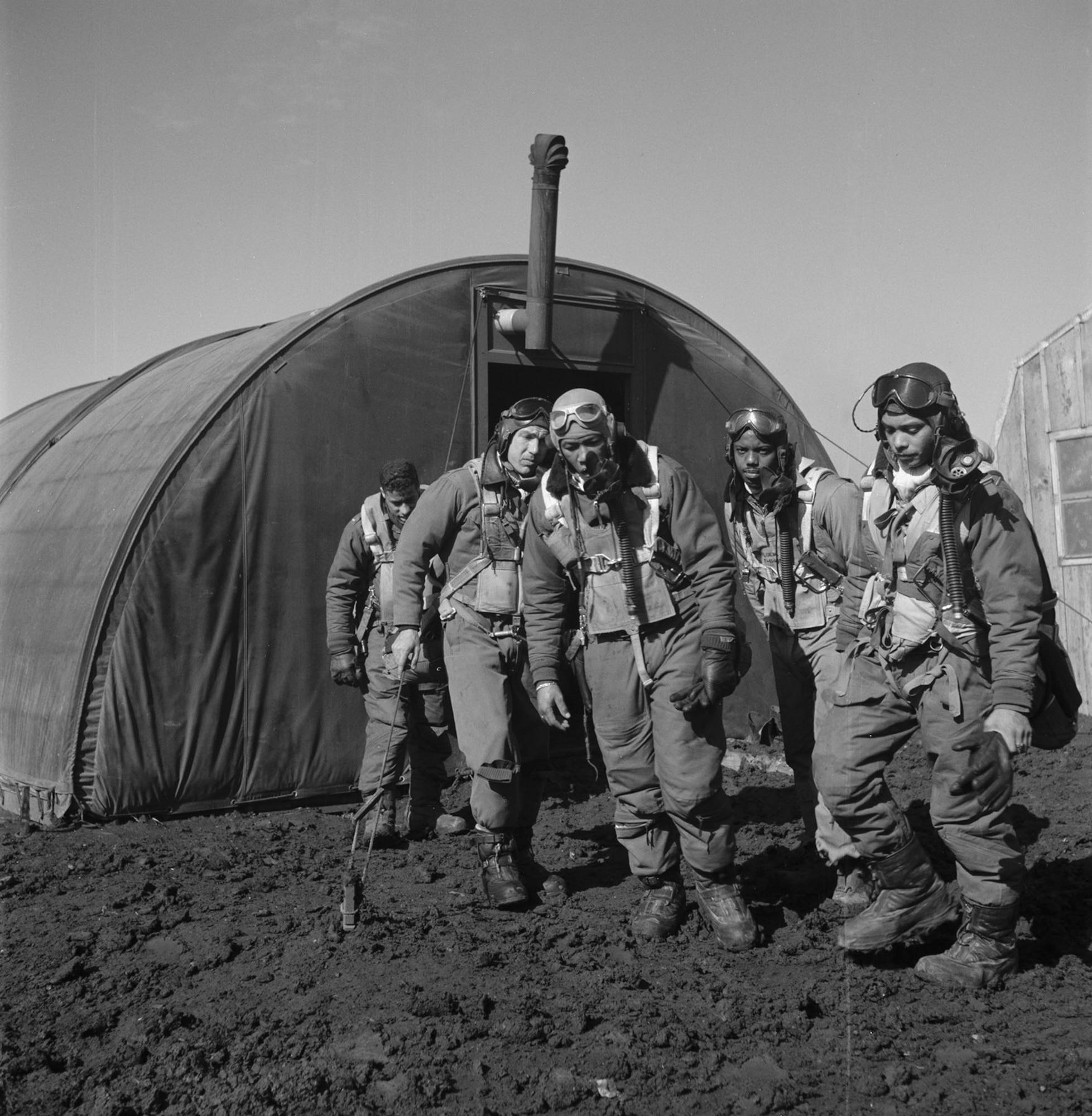 Living conditions were often difficult. Here, pilots are outside the parachute room at Ramitelli, Italy, before a mission (March 1945). (U.S. Air Force photo)