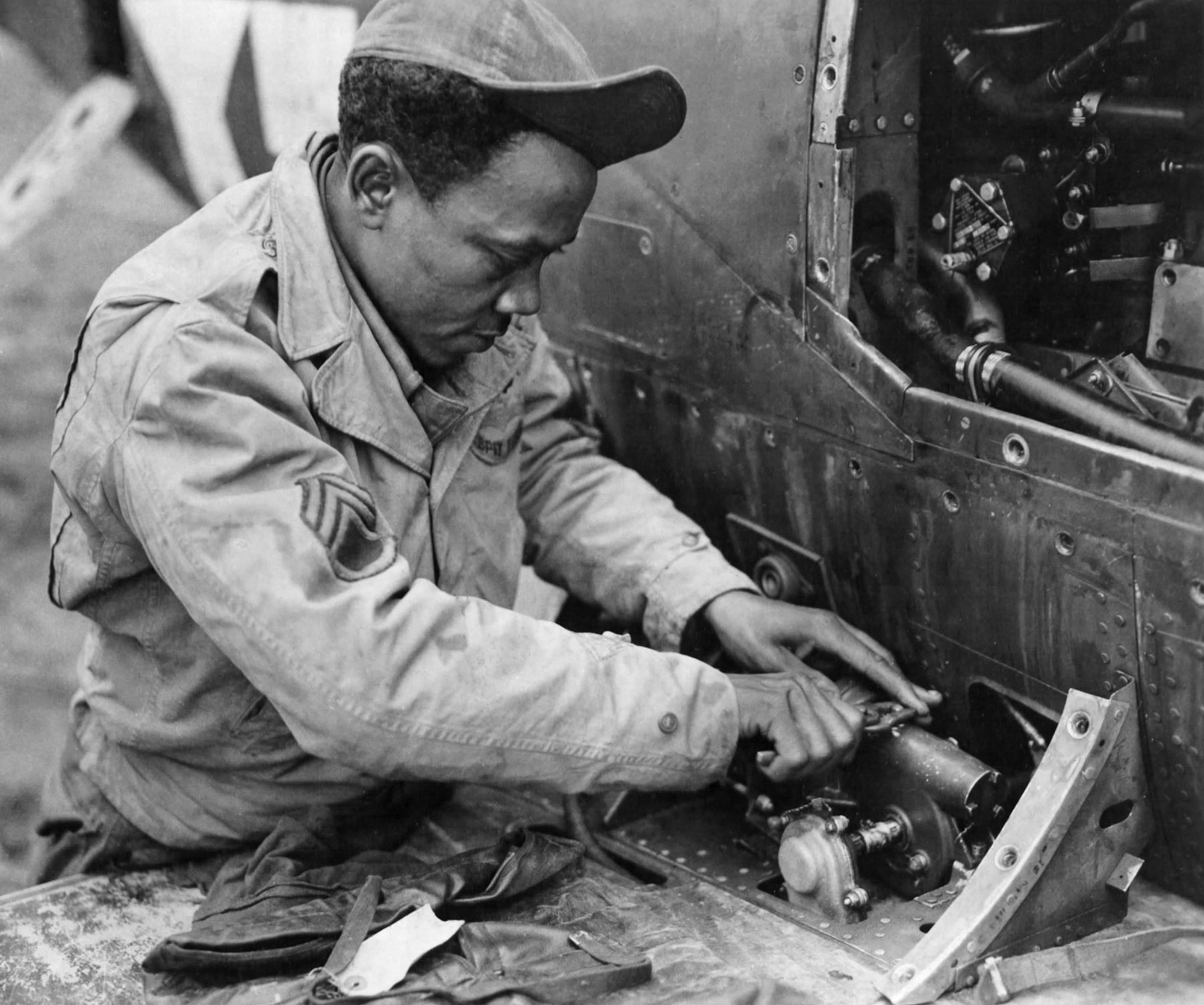 Staff Sgt. James McGee, shown working on one of the 332nd Fighter Group’s P-39 Airacobras in Italy, kept their aircraft combat ready. (U.S. Air Force photo)
