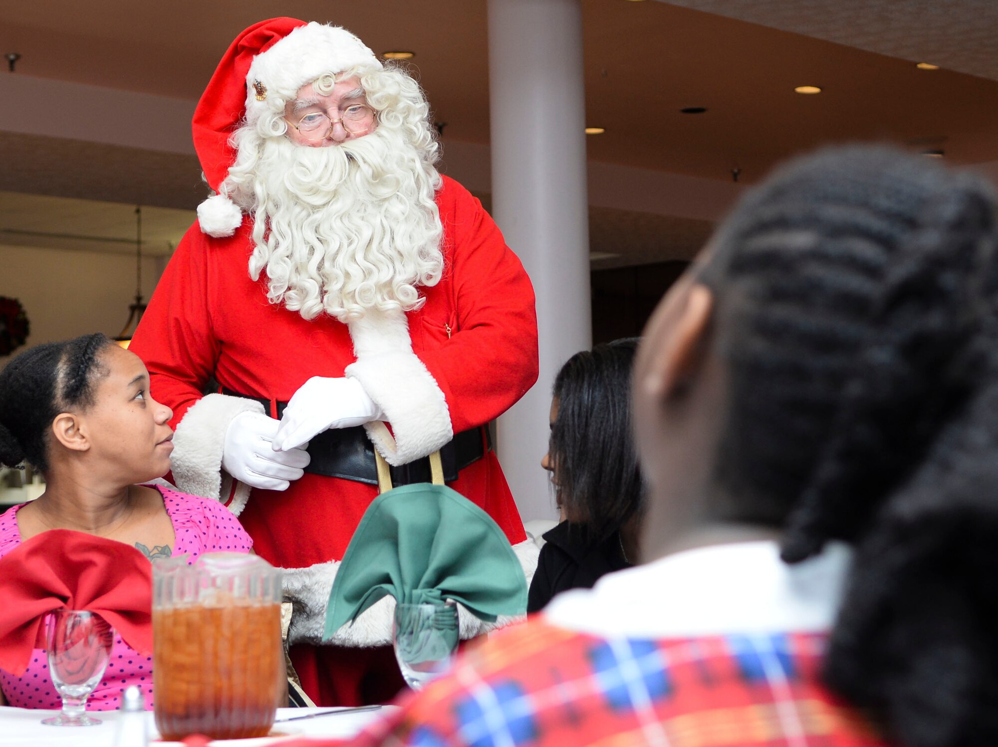 Santa Claus talks to children during Breakfast with Santa at Fort Eustis, Va., Dec. 6, 2014. Participants enjoyed a full buffet, a movie and other activities during the event. (U.S. Air Force photo by Senior Airman Austin Harvill/Released)