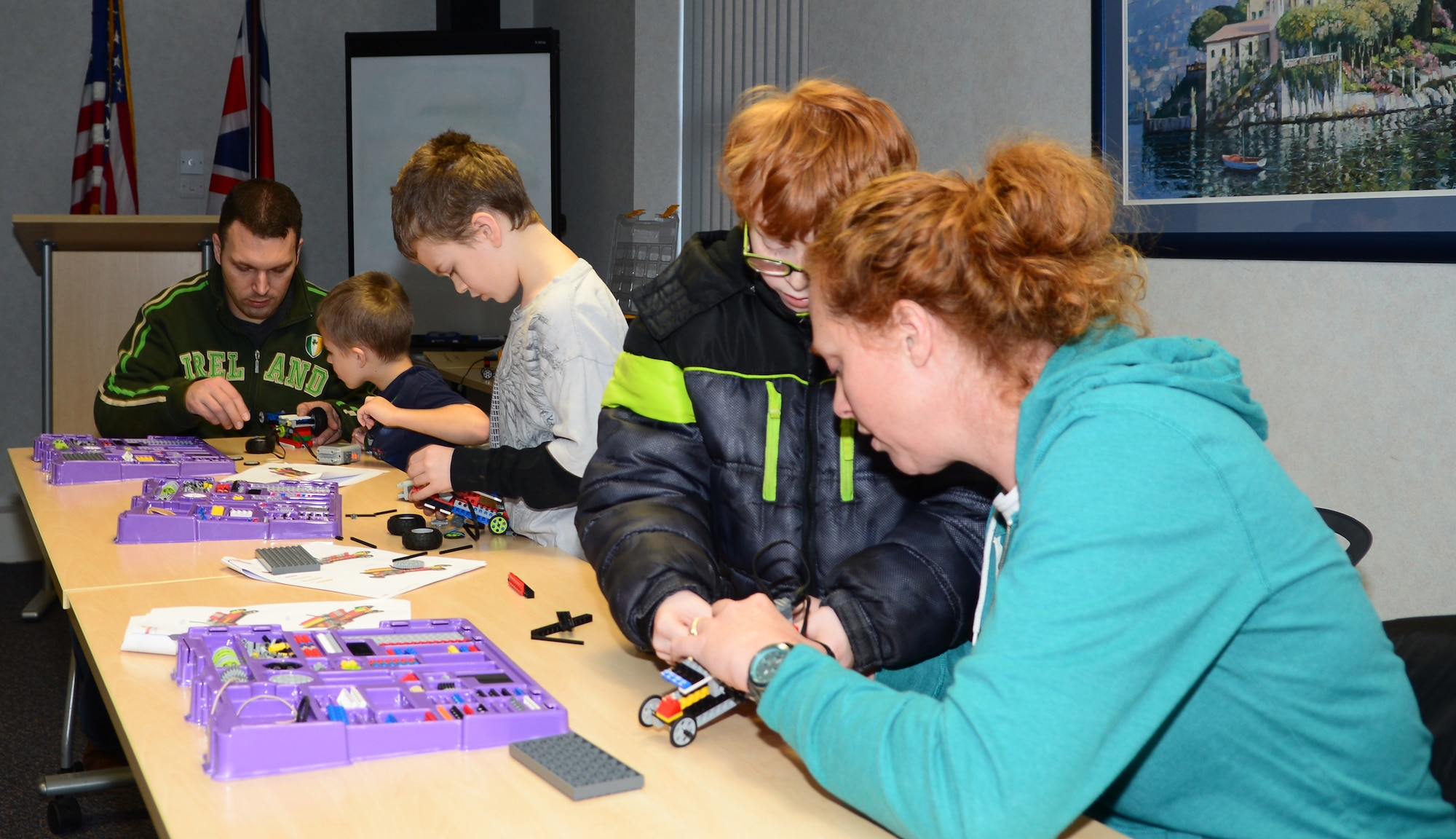 Team Mildenhall members help their children build miniature motorized vehicles during the Young Engineer Camp Dec. 6, 2014, at the Airman and Family Readiness Center on RAF Mildenhall, England. The camp was designed to give RAF Mildenhall’s exceptional family members a friendly learning environment with peers of similar interest. (U.S. Air Force photo by Airman 1st Class Jonathan Light/Released)