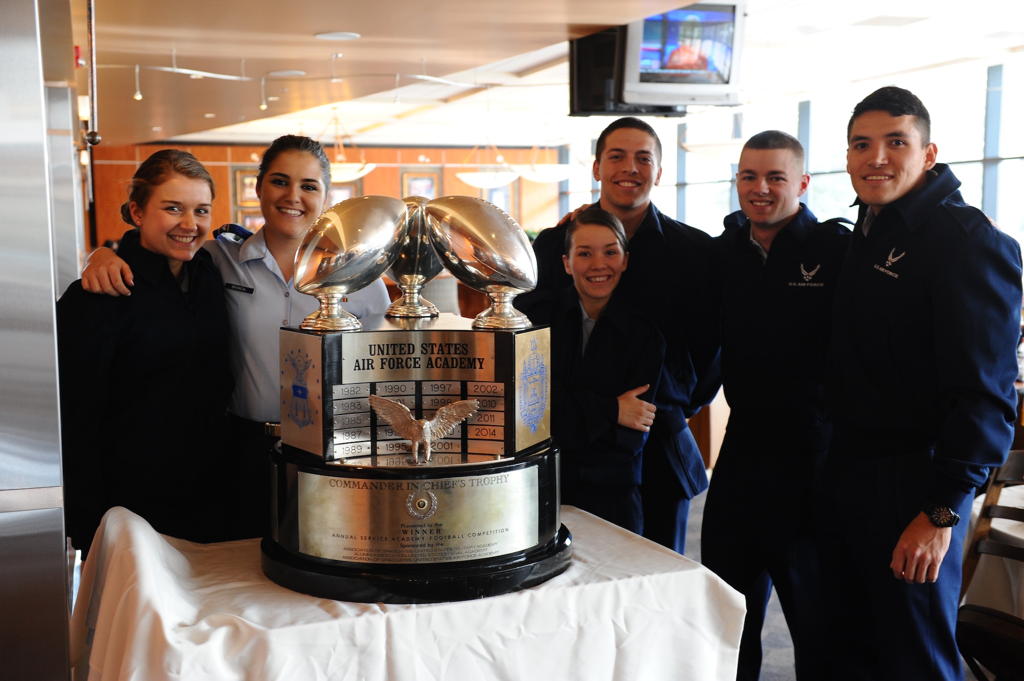 U.S. Air Force Academy Preparatory School cadet candidates gather around the Commander in Chief trophy at the High Country Inn dining facility Dec. 8, 2014. The trophy is making the rounds through the Academy for the next several weeks. (U.S. Air Force photo/Airman 1st Class Rachel Hammes)
