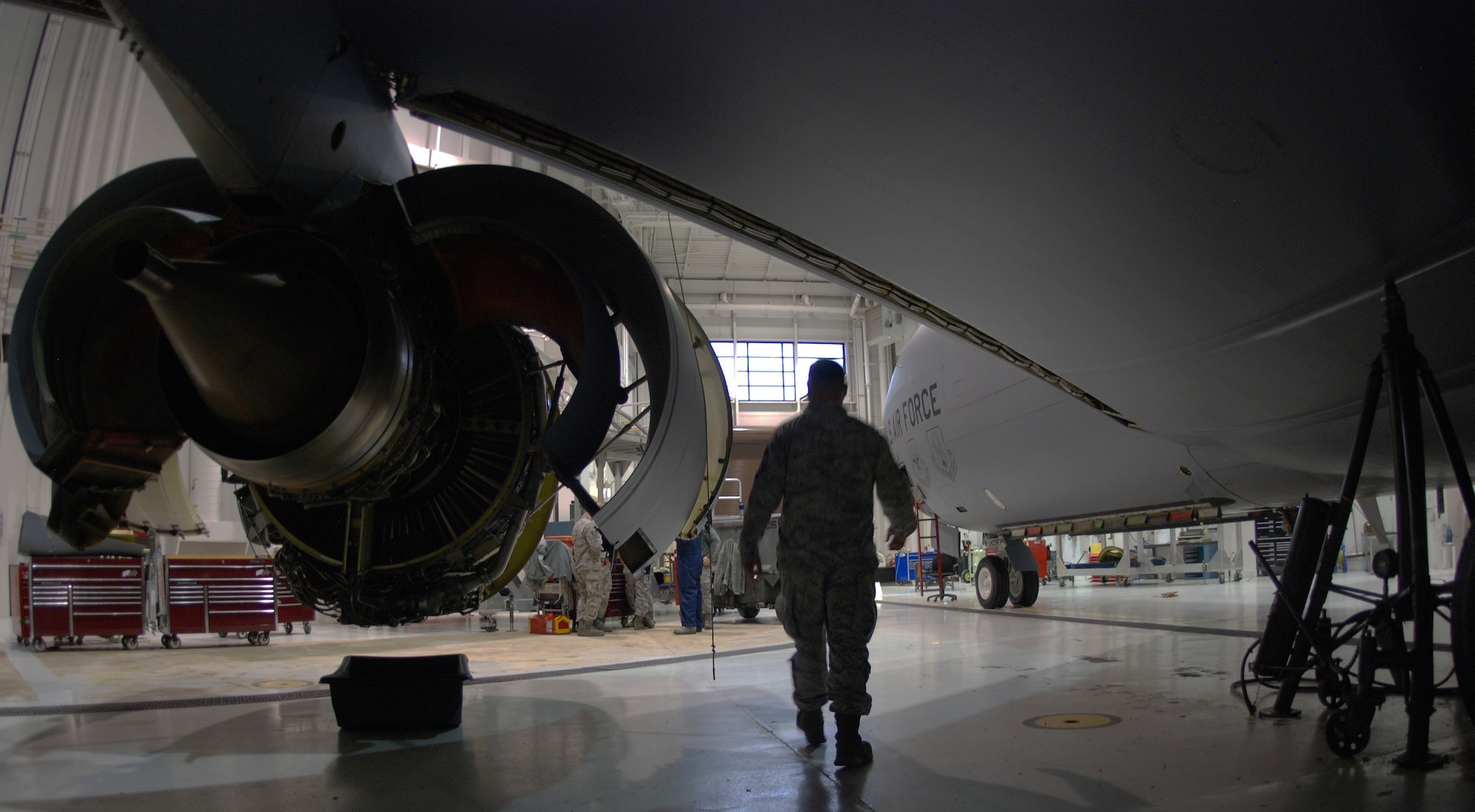 Senior Master Sgt. Martin Curry, 931st Maintenance Squadron Maintenance Flight Chief, walks under the wing of a KC-135 Stratotanker during a periodic inspection, McConnell Air Force Base, Kan., Dec. 7, 2014.  Curry operated a hydraulic test stand to move the aircraft landing gear during the inspection, which included lifting the aircraft 4 inches above the floor of Hangar 10.  (U.S. Air Force Photo by Tech. Sgt. Abigail Klein)