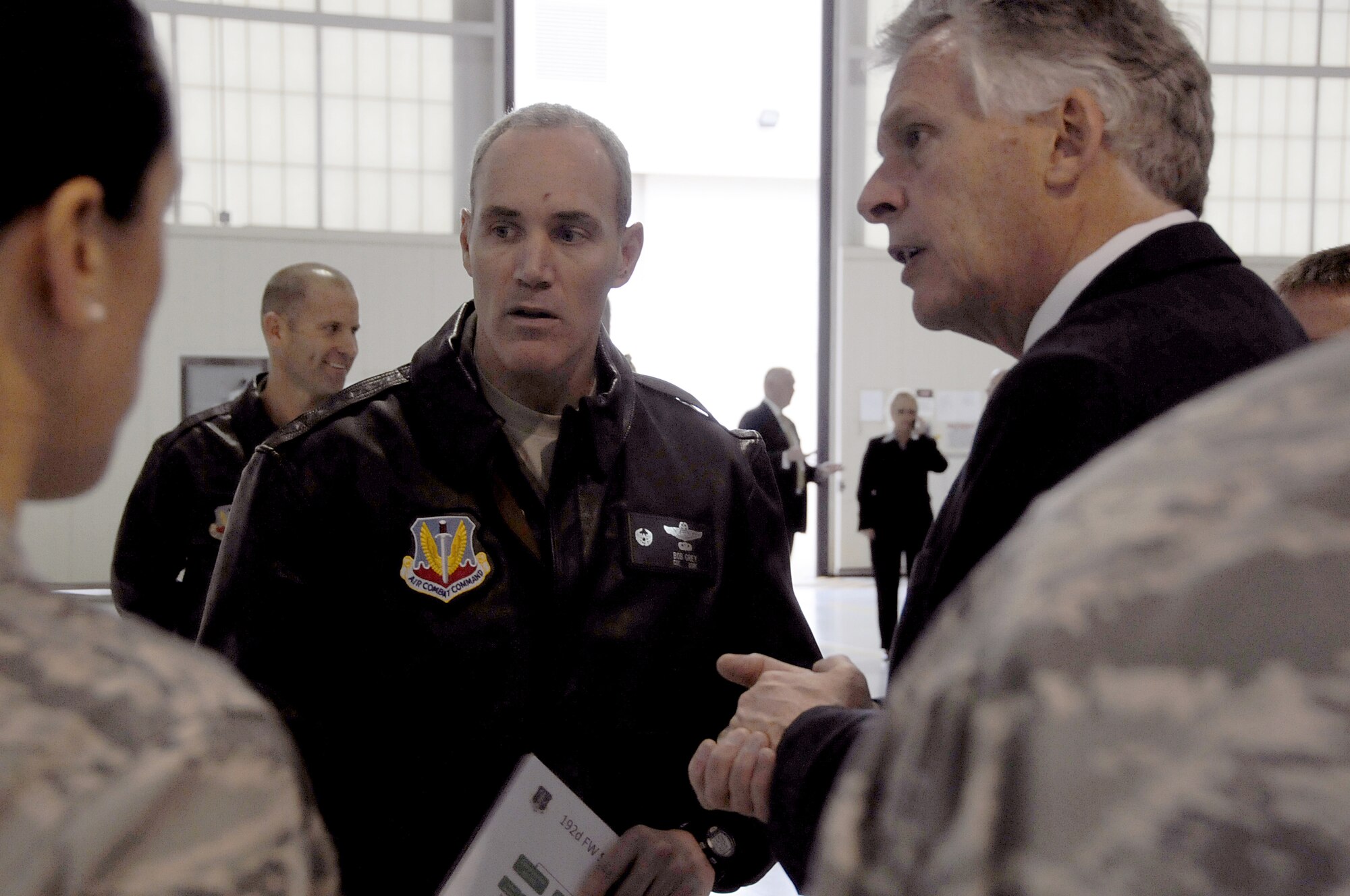 Virginia Gov. Terry McAuliffe and Col. Robert Grey, Virginia Air National Guard’s 192D Fighter Wing commander, listen to a mission brief by 192D FW personnel during a visit to Langley Air Force Base, Va., Dec. 2, 2014. (U.S. Air Force photo by Master Sgt. Carlos J. Claudio/Released)