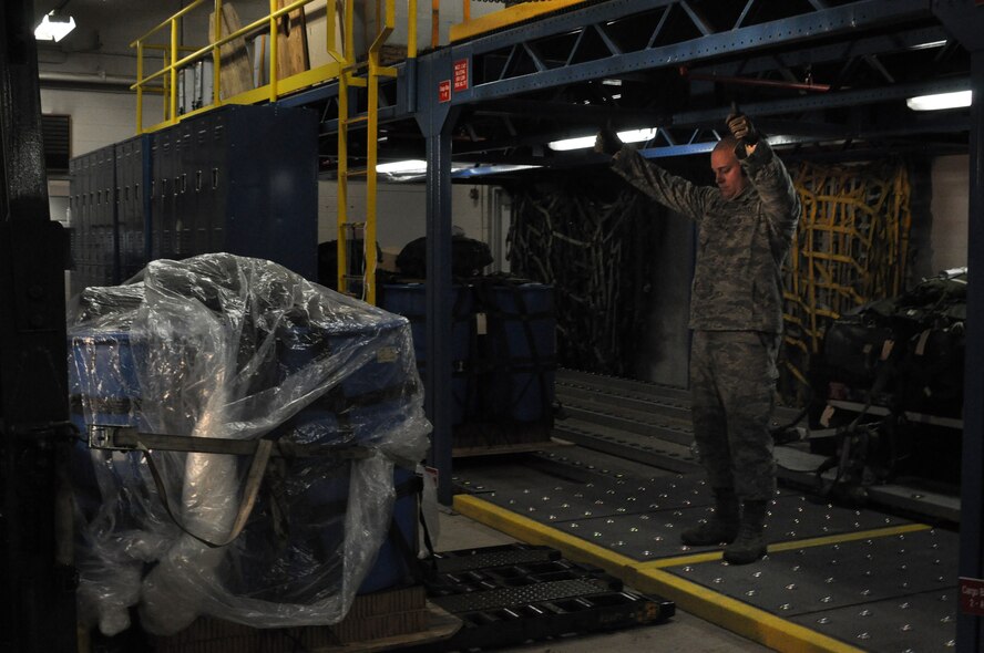 Airman 1st Class James Yamnitzky, 32nd Aerial Port Squadron air transportation specialist, gives the “all clear” for the driver of the 10K all-terrain vehicle to start backing out of the cargo garage at Pittsburgh International Airport Air Reserve Station, Dec. 6th, 2014. Transportation of cargo is vital to quickly and efficiently load a plane for take-off. (U.S. Air Force photo by Senior Airman Justyne Obeldobel)