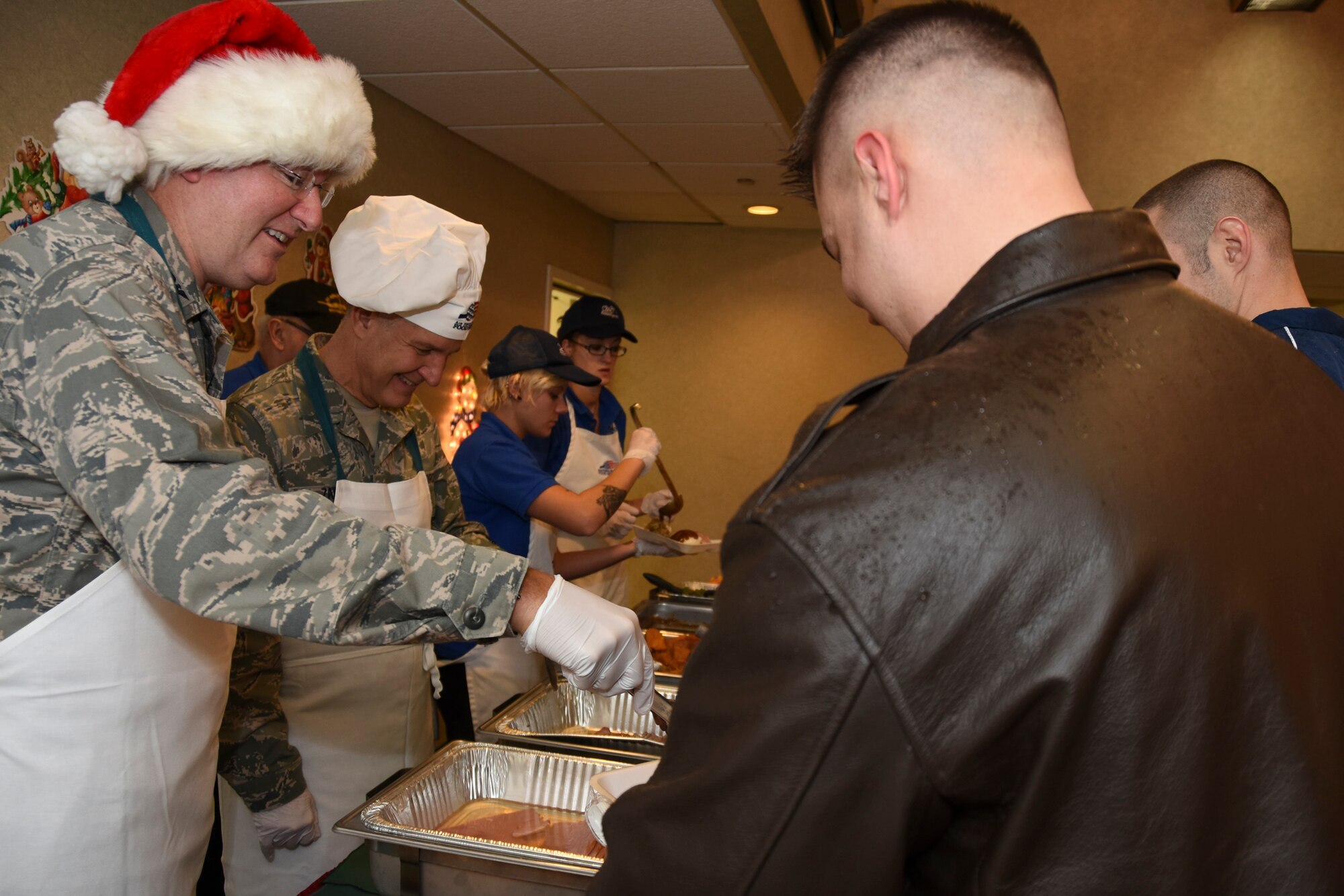 Col. Jeffrey A. Van Dootingh, 911th Airlift Wing commander, and Chief Master Sgt. Brian L. Zator, 911th AW command chief, serve food to Airmen during the holiday meal at the Pittsburgh International Airport Air Reserve Station, Dec. 6, 2014. (U.S. Air Force photo by Senior Airman Joshua J. Seybert)