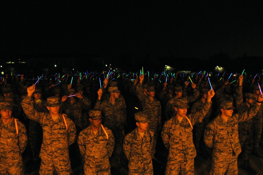 Holding up glow sticks to represent sexual assault victims they know, technical school Airmen listen to remarks from Col. George Tombe, 81st Training Group commander, before the third “Campaign to Zero” event takes place Dec. 4, 2014, at the Vandenberg Commons, Keesler Air Force Base, Miss. More than 800 students attended the event. (U.S. Air Force photo by Airman 1st Class Duncan McElroy/Released)