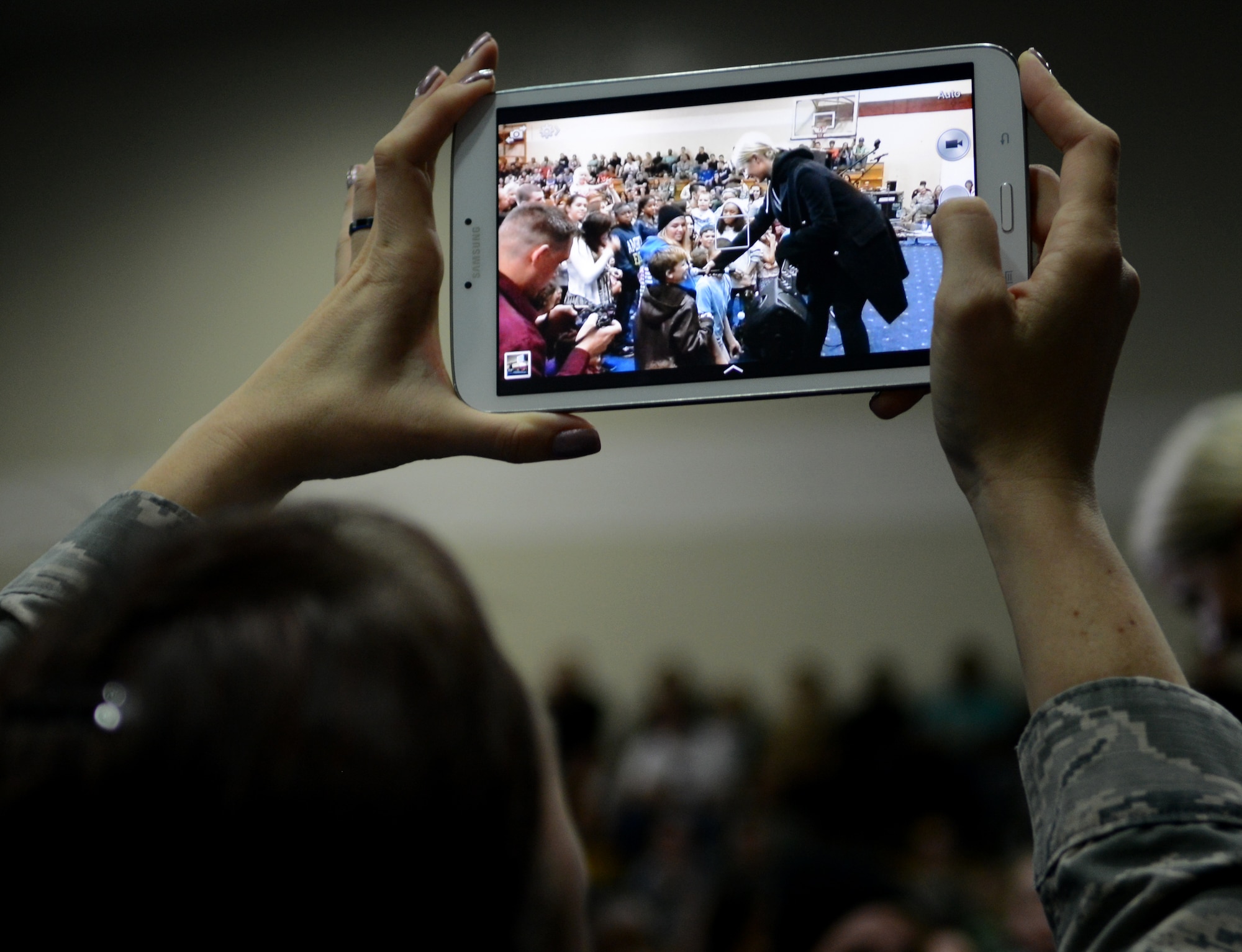 A member of Team Incirlik photographs actress Dianna Agron during a United Service Organizations holiday tour Dec. 8, 2014, at Incirlik Air Base, Turkey. The USO tour brought in the Chairman of the Joint Chiefs of Staff, Gen. Martin Dempsey, actress and singer Dianna Agron, Washington Nationals pitcher Doug Fister, actress Meghan Markle, country artist Kellie Pickler, actor and comedian Rob Riggle, and Brian Urlacher, Chicago Bears pro-bowler and former linebacker. (U.S. Air Force photo by Staff Sgt. Caleb Pierce/Released)