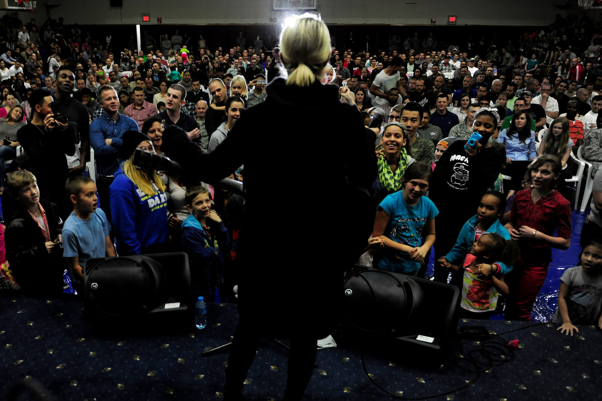 Dianna Agron, singer and actress touring with the United Service Organizations holiday tour, sings to a crowd of service members and their families Dec. 8, 2014, at Incirlik Air Base, Turkey. The tour is part of a USO tradition to bring a touch of home to troops abroad during the holiday season. (U.S. Air Force photo by Senior Airman Krystal Ardrey/Released)