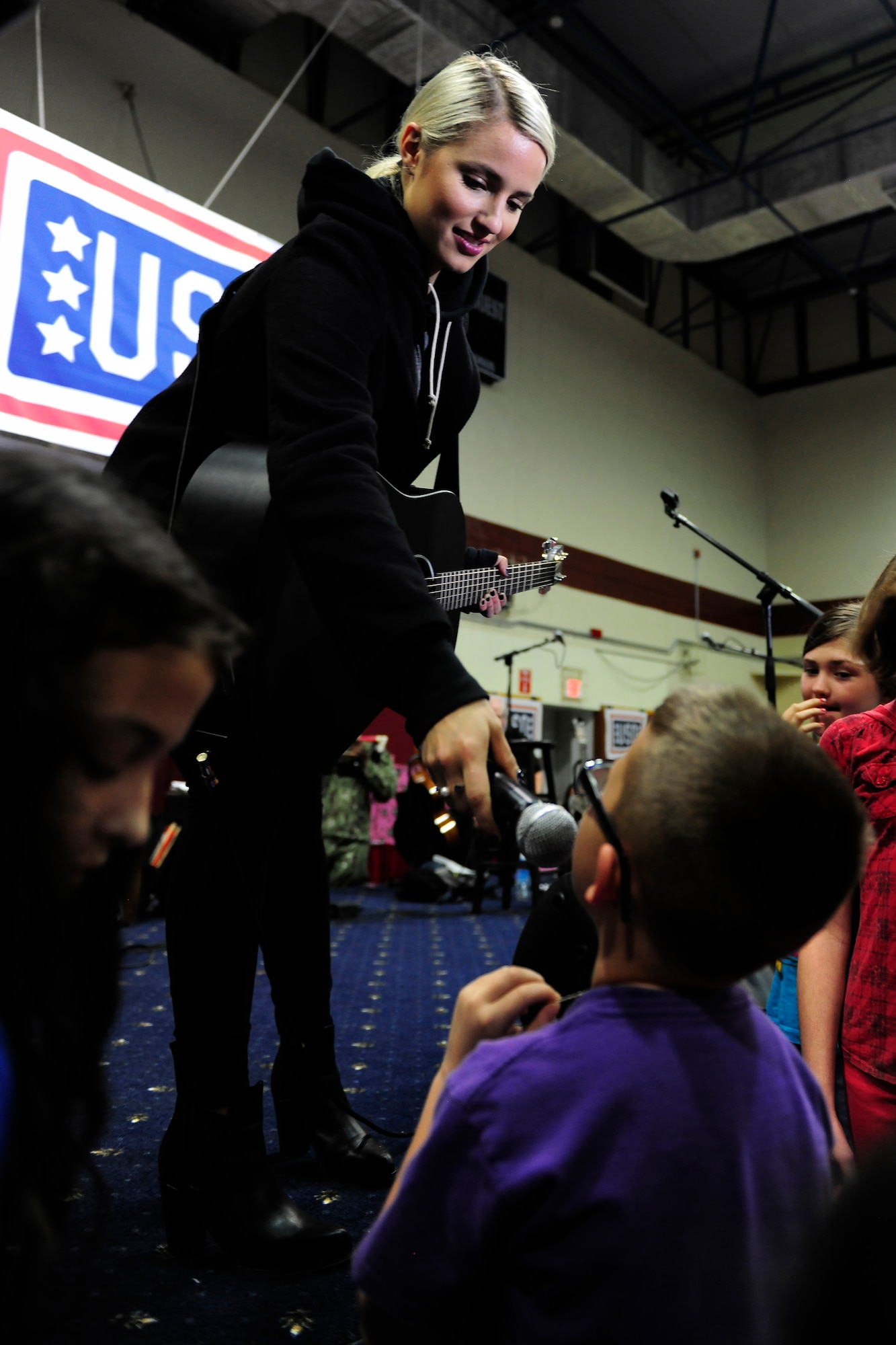 Dianna Agron, a singer and actress, speaks with audience members during a United Service Organizations holiday tour, Dec. 8, 2014, at Incirlik Air Base, Turkey. Agron is touring with five other celebrities and the Chairman of the Joint Chiefs of Staff to various overseas bases to bring a touch of home to those stationed there during the holidays. (U.S. Air Force photo by Senior Airman Krystal Ardrey/Released)