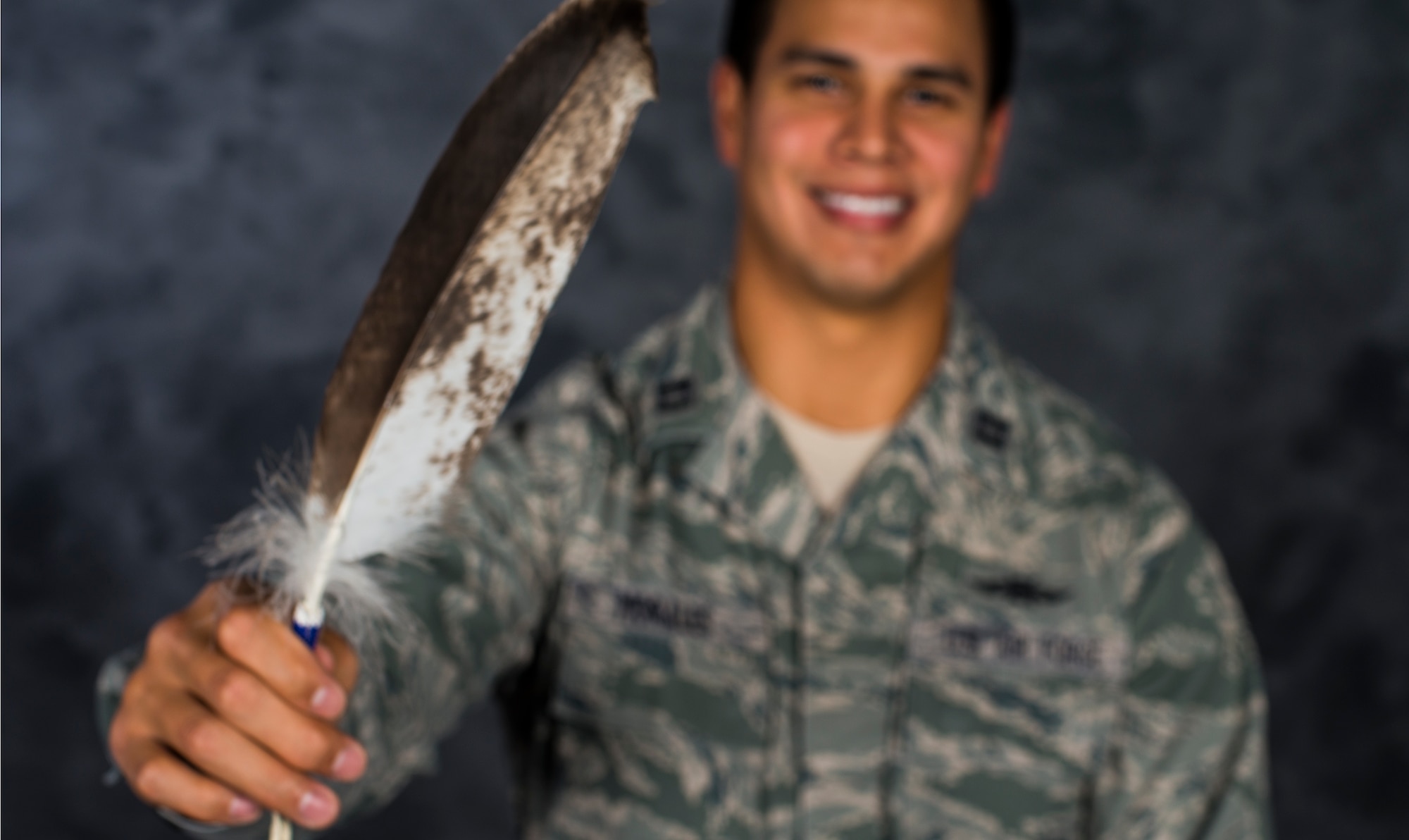 U.S. Air Force Capt. Myles Morales, 336th Recruiting Squadron support flight commander, poses for a photo holding his eagle feather Dec. 3, 2014, at Moody Air Force Base, Ga. Morales received the eagle feather during a naming ceremony held in his honor by the Lakota Sioux tribe on Standing Rock Reservation, South Dakota. (U.S. Air Force photo by Airman 1st Class Ceaira Tinsley/Released)