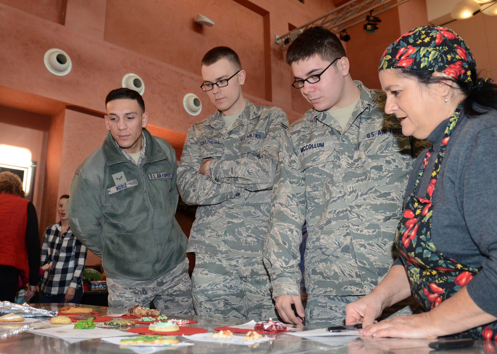 Airmen from the 31st Communication Squadron judge the ‘best-looking cookie’ contest during the Aviano Cookie Drive, Dec. 8, 2014, at Aviano Air Base, Italy. The volunteer who made the most appealing and the most tasteful cookie received a $50 Exchange gift card. The drive was hosted by the Aviano Officers and Civilians Spouses' Club. (U.S. Air Force photo/Airman 1st Class Deana Heitzman)         