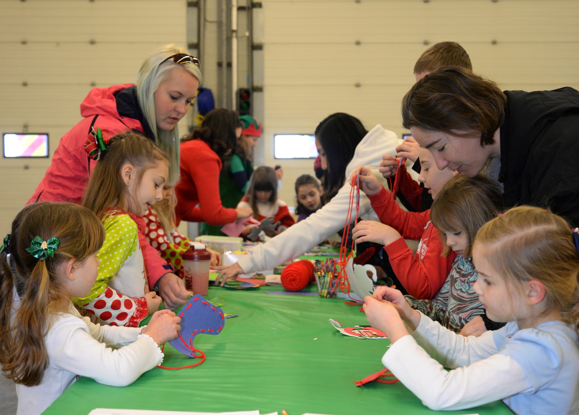Team Mildenhall children make arts and crafts during Breakfast with Santa Dec. 6, 2014, on RAF Mildenhall, England. Arts and crafts, games and child friendly activities were offered during the event. (U.S. Air Force photo by Airman 1st Class Dillon Johnston/Released)