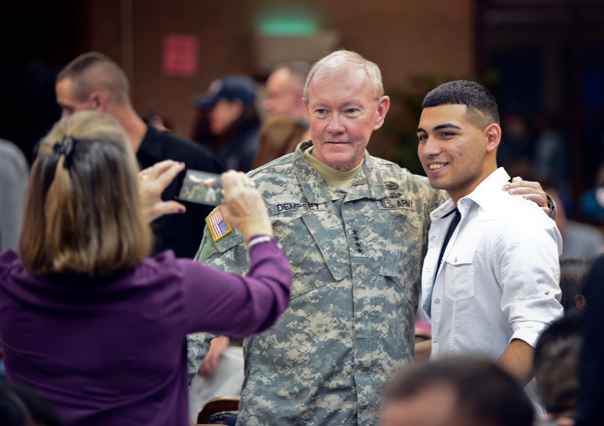 Chairman of the Joint Chiefs of Staff, Gen. Martin Dempsey, takes a picture with an Airman at a USO Holiday Troop Visit dinner Dec. 8, 2014, at Incirlik Air Base, Turkey. The Chairman is on his final Holiday Tour visiting with Airmen serving abroad. (U.S. Air Force photo by Airman Cory W. Bush/Released)
