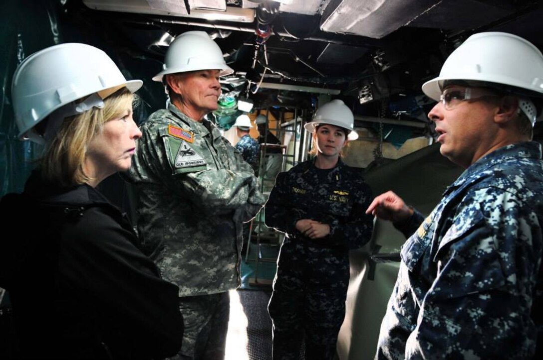 U.S. Navy Cmdr. Tadd Gorman, right, commanding officer of the USS Ross, explains a recent patrol to U.S. Army Gen. Martin Dempsey, chairman of the Joint Chiefs of Staff, center, and his wife, Deanie, during a ship tour on Naval Station Rota, Spain, Dec. 6, 2014. 