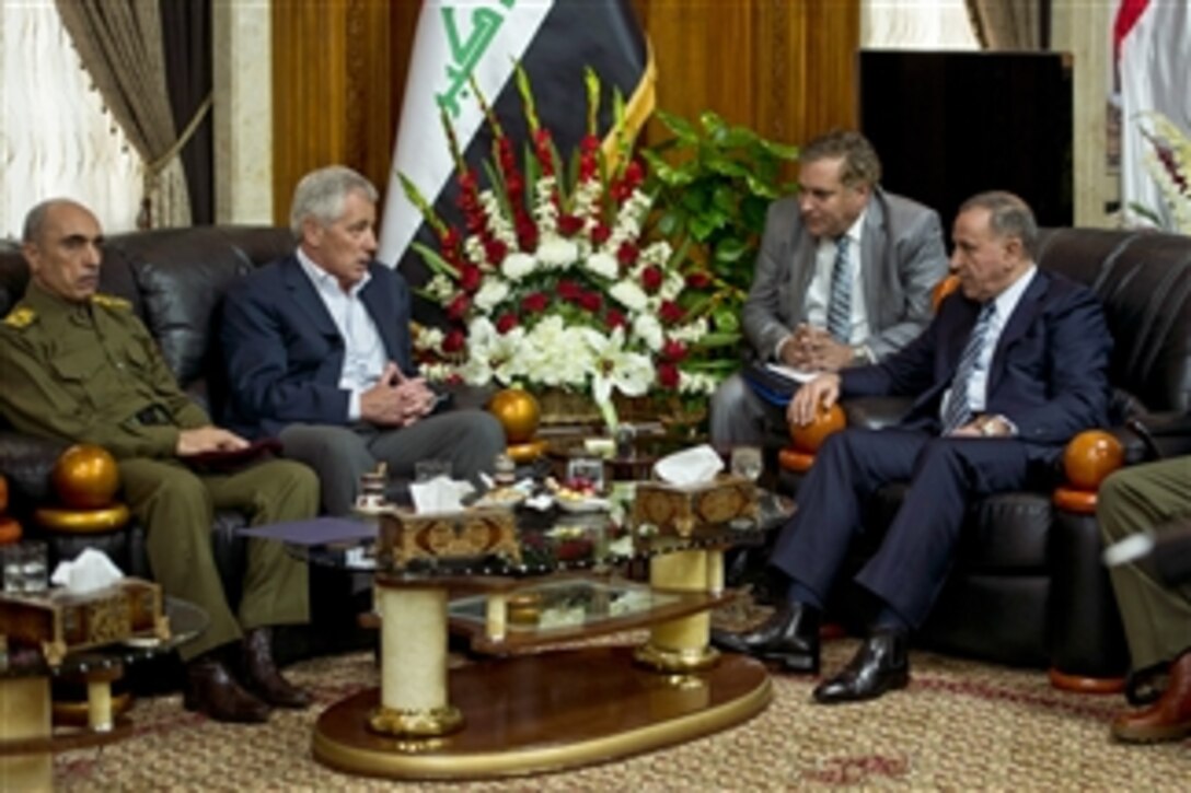 U.S. Defense Secretary Chuck Hagel, second from left, meets with Iraqi Defense Minister Khalid al-Ubaidi, right, to discuss matters of mutual importance during a visit to Iraq, Dec. 9, 2014.