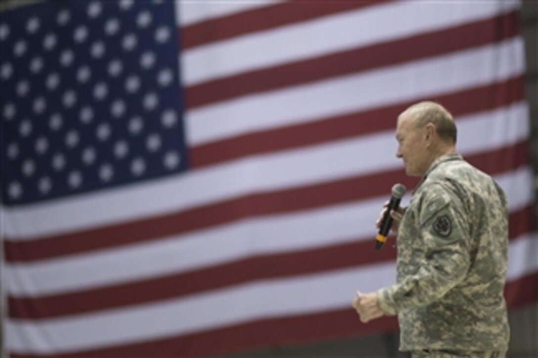 U.S. Army Gen. Martin E. Dempsey, chairman of the Joint Chiefs of Staff, addresses the audience at a USO holiday show on Bagram Airfield, Afghanistan, Dec. 8, 2014.