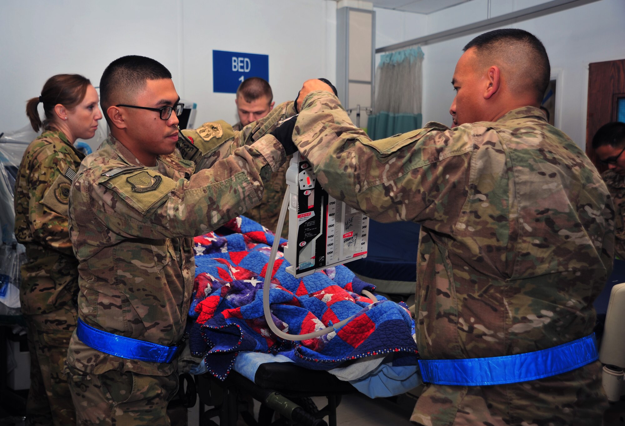 U.S. Air Force Airmen prepare equipment necessary to transport a medical mannequin during a training scenario Dec. 6, 2014 at Bagram Airfield, Afghanistan. Aeromedical Evacuation and Critical Care Air Transportation team members were on hand to practice their varying parts in the transportation process. (U.S. Air Force photo by Staff Sgt. Whitney Amstutz/released)