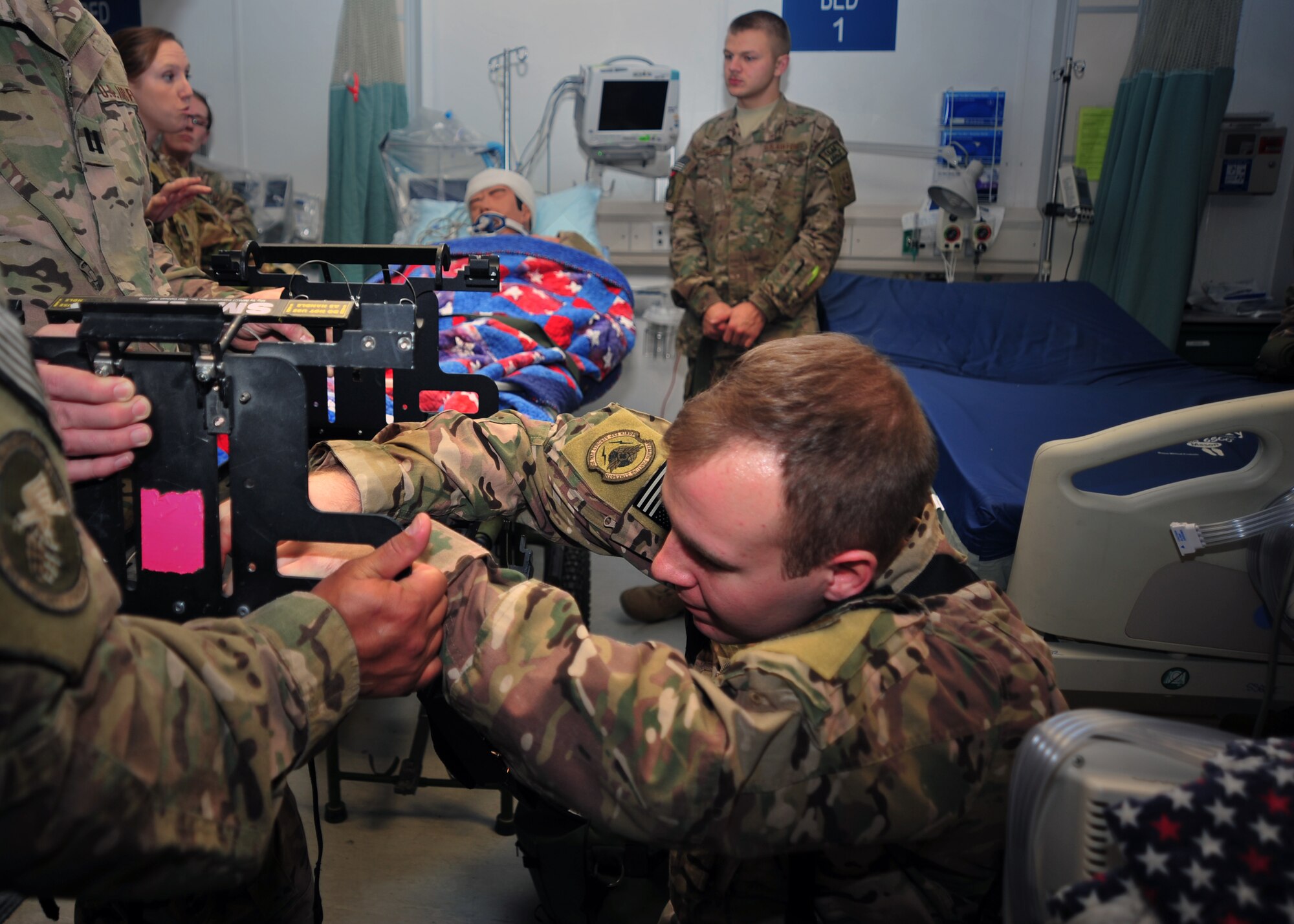 U.S. Air Force Staff Sgt. John Susalla, 455th Expeditionary Aeromedical Evacuation Squadron, prepares a Special Medical Emergency Evacuation Device prior to attaching it to a gurney during a patient transportation training scenario Dec. 6, 2014 at Bagram Airfield, Afghanistan. The scenario was designed to refine skills, communication and streamline critical transport processes. (U.S. Air Force photo by Staff Sgt. Whitney Amstutz/released)