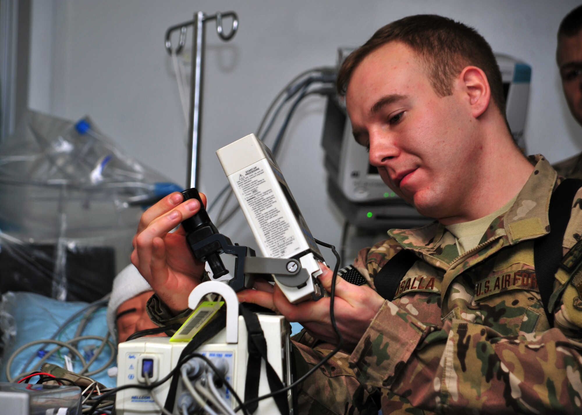 U.S. Air Force Staff Sgt. John Susalla, 455th Expeditionary Aeromedical Evacuation Squadron, installs equipment necessary for patient travel during a medical transportation training scenario Dec. 6, 2014 at Bagram Airfield, Afghanistan. Before being transported to the aircraft, all medical equipment necessary to sustain and monitor the patient during flight must be secured to a Special Medical Emergency Evacuation Device. (U.S. Air Force photo by Staff Sgt. Whitney Amstutz/released) 