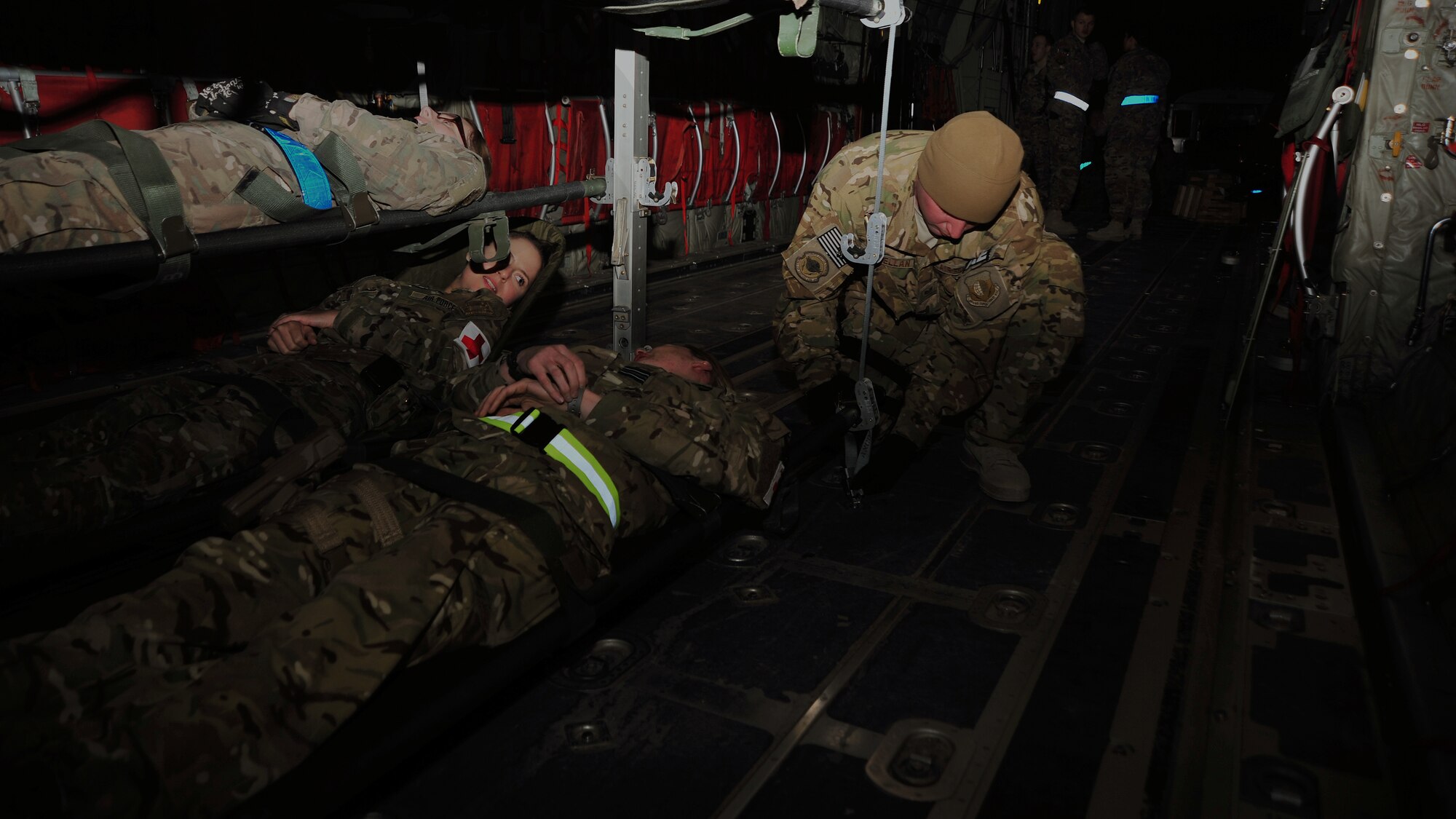 U.S. Air Force Staff Sgt. Ryan McClellan, 455th Expeditionary Aeromedical Evacuation Squadron, secures patient litters to an aircraft during a medical transportation training scenario Dec. 6, 2014. The training incorporated all aspects of patient transportation from attaching a Special Medical Emergency Evacuation Device, to stabilizing monitors and necessary equipment on the SMEED, loading the patient onto an ambulance bus and finally, securing the gurney on the aircraft and prepping for takeoff. (U.S. Air Force photo by Staff Sgt. Whitney Amstutz/released)