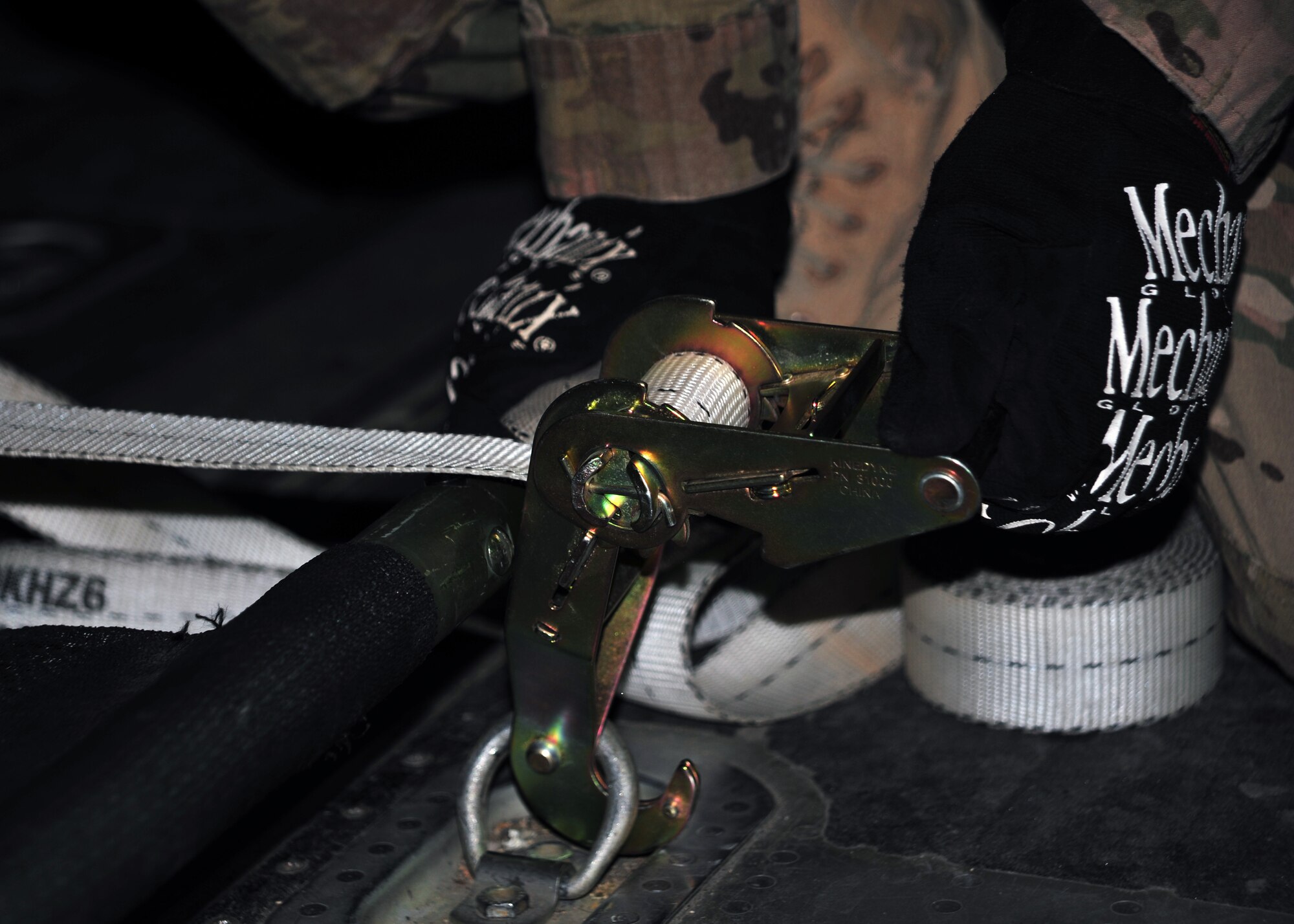 A U.S. Air Force Airman assigned to the 455th Expeditionary Medical Group’s Contingency Aeromedical Staging Facility secures patient litters to the floor of an aircraft during a training scenario Dec. 6, 2014. The training helped to enhance the skillsets of both Airmen and their allied counterparts. (U.S. Air Force photo by Staff Sgt. Whitney Amstutz/released)