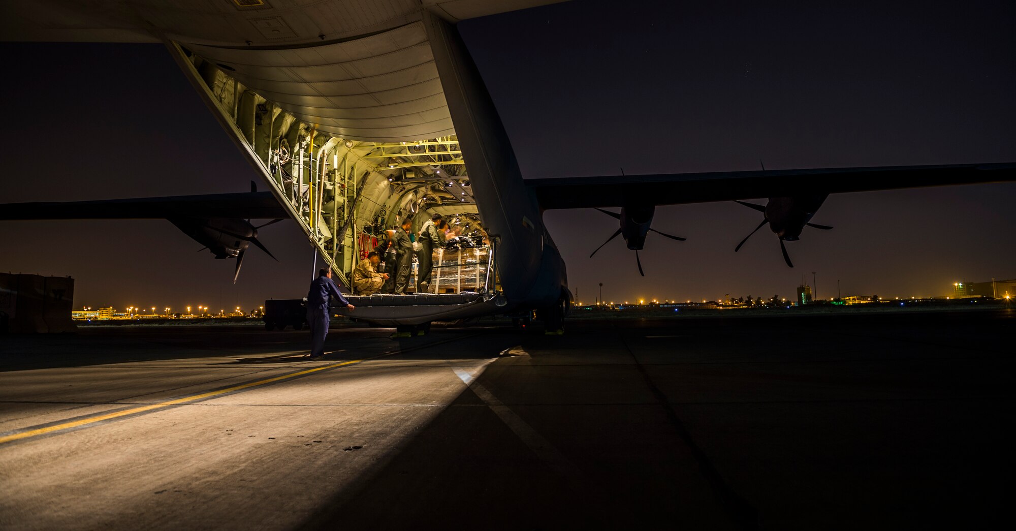 Members of the Iraqi air force load pallets of food and water onto an Iraqi C-130J Super Hercules Aug. 29, 2014 in Baghdad, Iraq. After working alongside the United States Air Force during a military to military engagement, the Iraqi air force successfully dropped five bundles delivering food and water to citizens in Amirli, Iraq Aug. 30, 2014. (U.S. Air Force photo by Staff Sgt. Jeremy Bowcock/released)