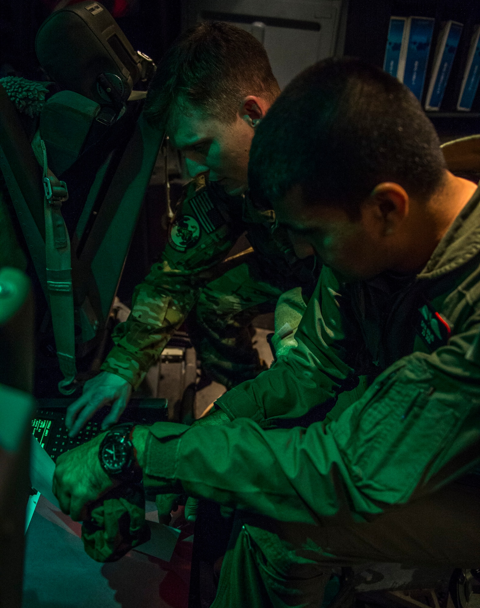 SOUTHWEST ASIA - U.S. Air Force Lt. Col. Greg Young, 386th Expeditionary Operations Support Squadron commander deployed from the 24th Airlift Squadron, Ramstein, Germany, works alongside an Iraqi air force pilot to discuss final mission plans Aug. 29, 2014. The Iraqi air force delivered five bundles of food and water to citizens in Amirli, Iraq after working with United States Air Force pilots and loadmasters from the 737th Expeditionary Airlift Squadron on mission planning and bundle rigging. (U.S. Air Force photo by Staff Sgt. Jeremy Bowcock/released)