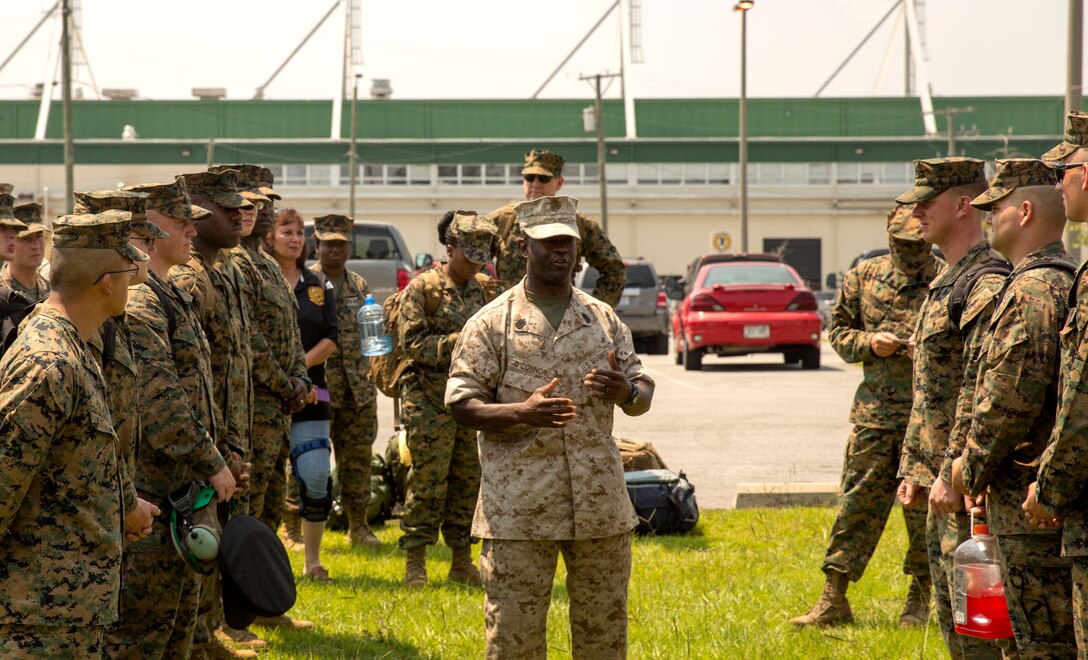 Sgt. Maj. Clive O'Connor, the sergeant major of Marine Operational Test and Evaluation Squadron 22, speaks to his Marines prior to the unit’s first deployment, July 9. The Marine Corps Air Station New River Marines deployed to support Special Marine Air Ground Task Force-South aboard USS America on its maiden voyage. O’Connor shared guidance with his troops, emphasizing the importance of safety.  