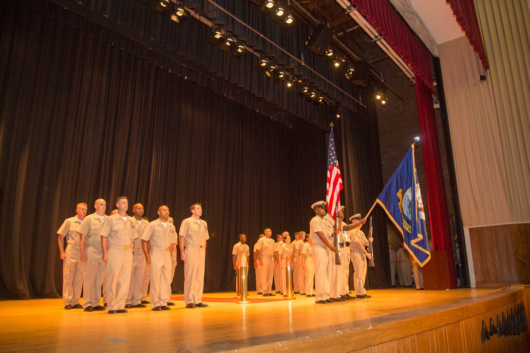 The color guard stands in front of Marine Corps Base Camp Lejeune’s newest chief petty officers at the opening of their induction ceremony, at the base theater aboard the Marine Corps Base Camp Lejeune, September 16. Twenty-two sailors from area units earned the promotion to E-7 after undergoing testing, a selection board and a six-week induction program.