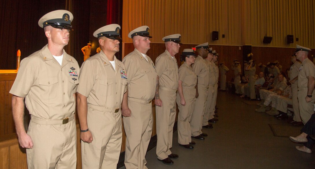 Marine Corps Base Camp Lejeune’s newest chief petty officers stand before their guests at the conclusion of their induction ceremony, at the base theater aboard the Marine Corps Base Camp Lejeune, September 16. Twenty-two sailors from area units earned the promotion to E-7 after undergoing testing, a selection board and a six-week induction program.