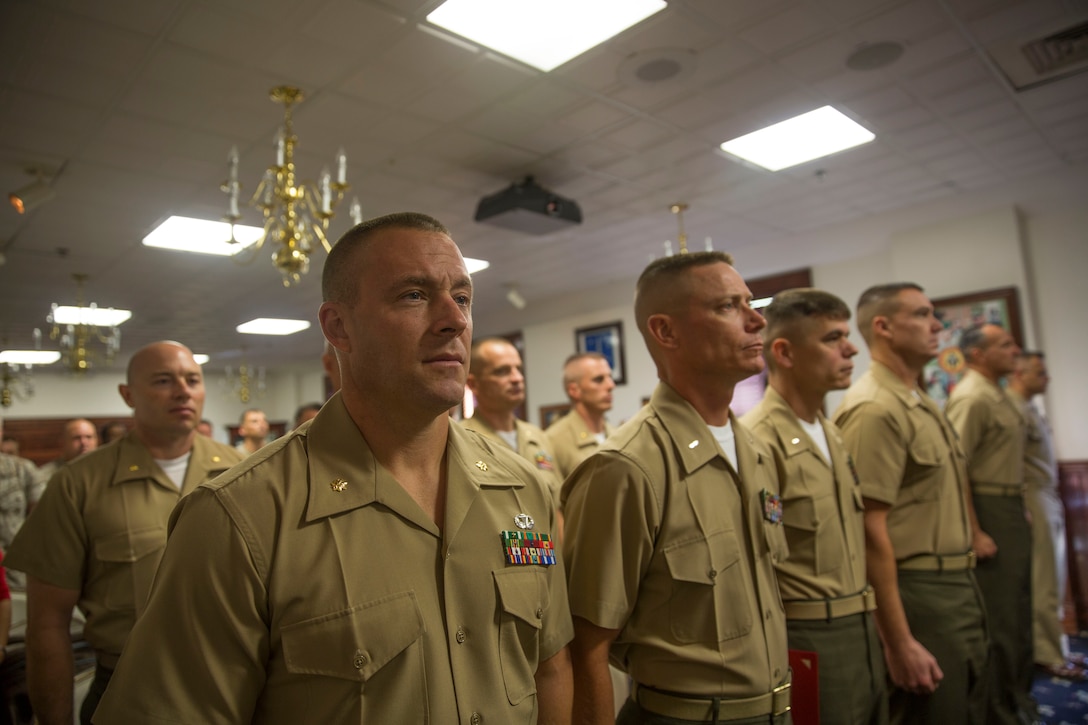 Maj. Audie T. Cooper, a student with Camp Lejeune’s inaugural Command and Staff College Blended Seminar Program, stands with classmates and guests during the course’s graduation ceremony held at the Officers’ Club aboard Marine Corps Base Camp Lejeune, Sept. 4. The Command and Staff College Blended Seminar Program is a distance professional military education course for Chief Warrant Officer 4, Marine field grade and other service field grade officers. The course offers instruction in the small wars, joint warfighting, amphibious operations and operational planning, among a slew of courses designed to prepare field grade officers for higher level billets. Cooper, and the nine other students, were the first graduates of the blended seminar on the East Coast, a similar course was offered in the West Coast which concluded around the same time. Blended seminars are a new approach to distance education, where students participate in periods of focused education with daily classes and periods of online lessons.