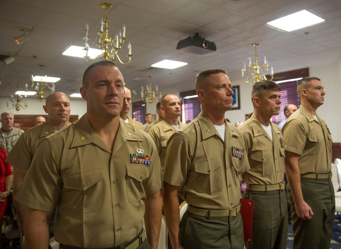 Maj. Audie T. Cooper, a student with Camp Lejeune’s inaugural Command and Staff College Blended Seminar Program, stands with classmates and guests during the course’s graduation ceremony held at the Officers’ Club aboard Marine Corps Base Camp Lejeune, Sept. 4. The Command and Staff College Blended Seminar Program is a distance professional military education course for Chief Warrant Officer 4, Marine field grade and other service field grade officers. The course offers instruction in the small wars, joint warfighting, amphibious operations and operational planning, among a slew of courses designed to prepare field grade officers for higher level billets. Cooper, and the nine other students, were the first graduates of the blended seminar on the East Coast, a similar course was offered in the West Coast which concluded around the same time. Blended seminars are a new approach to distance education, where students participate in periods of focused education with daily classes and periods of online lessons.