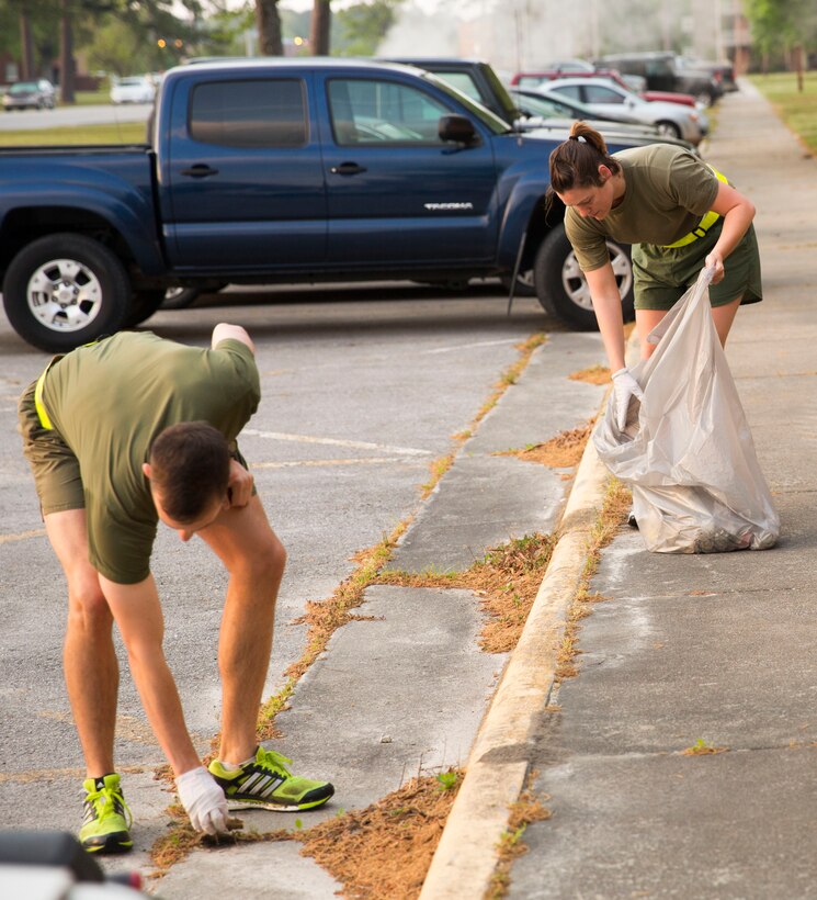 MARINE CORPS BASE CAMP LEJEUNE, N.C. – Sgt. Emily Peterson, a legal services specialist with Headquarters and Support Battalion, collects trash during the battalion’s Earth Day/Area Clean-up Run aboard Marine Corps Base Camp Lejeune, April 25. Service members with the battalion ran through the base’s Mainside area collecting trash and debris in observance of Earth Day. “(Headquarters and Support Battalion) picked up a lot of trash,” said Lt. Col. Harry L. Gardner, commanding officer of Headquarters and Support Battalion. While some trash collected was due to littering, some of it was displaced from area dumpsters due to strong winds, he added. “You helped better the environment. This is our base. We need to make sure we are working and living in a clean base.  (Camp Lejeune) leads the way when it comes to protecting the environment.” Various environmental programs throughout the base were recently recognized by the Secretary of the Navy and the Secretary of Defense for their efforts in protecting the environment. 