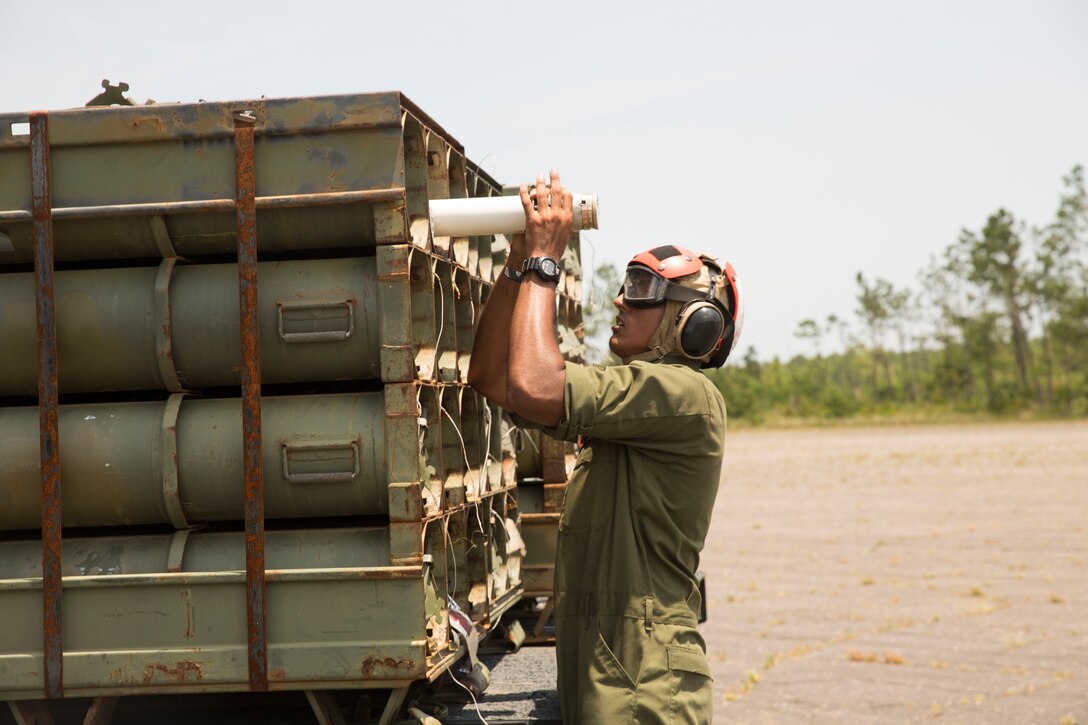 Lance Cpl. Mahavir Kallirai, an aviation ordnance technician with Marine Light Attack Helicopter Squadron 269 from Elk Grove Calif., handles ordnance for an AH-1W Super Cobra helicopter during Forward Arming and Refueling Point exercises at Marine Corps Outlying Field Camp Davis, near Holly Ridge, N.C., July 8. Throughout the week the Marines with HLMA-269 filled and reloaded aircraft 18 times with 200 to 300 gallons of fuel each time.