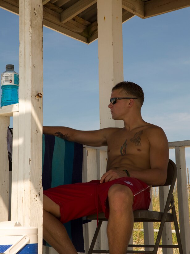 Lance Cpl. Damien Strait, a lifeguard with Headquarters Support Battalion’s Beach Detachment, watches over the shore of Onslow Beach aboard Marine Corps Base Camp Lejeune, August 28. The shores of the beach are guarded by 30 Marines who provide for the safety and cleanliness of the area annually, from Memorial Day to Labor Day. 