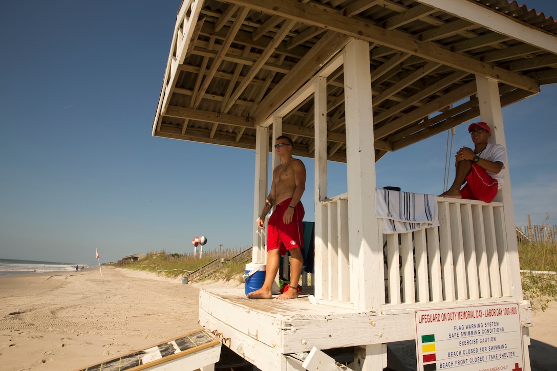 Cpl. Yorlin J. Barzola Ronquillo and Lance Cpl. Damien Strait, lifeguards with Headquarters Support Battalion’s Beach Detachment, watch over the shore of Onslow Beach aboard Marine Corps Base Camp Lejeune, August 28. The shores of the beach are guarded by 30 Marines who provide for the safety and cleanliness of the area annually, from Memorial Day to Labor Day. 