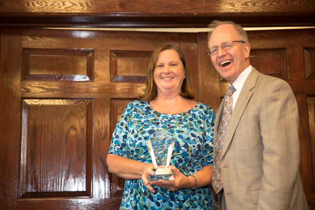 Donald R. Schregardus, the deputy assistant secretary of the Navy (Environment) and a native of Chagrin Falls, Ohio, presented a Secretary of the Navy Environmental Awards to Alicia Filzen, the winner for individual environmental quality, at the Officer’s Club aboard Marine Corps Base Camp Lejeune, Aug. 8. Filzen, a native of Jamestown, South Carolina, managed the Quality Recycling Program aboard the base and coordinated outreach events that led to an increased awareness of environmental issues.