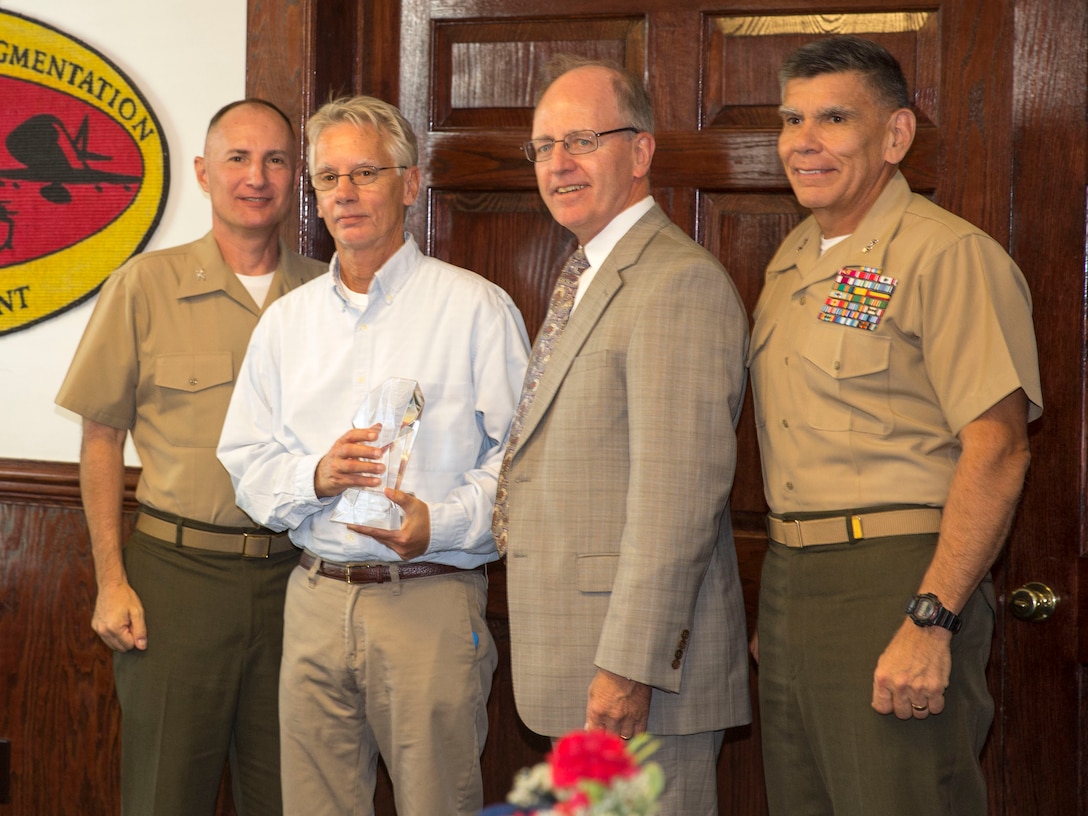 Rick Richardson, who represented Marine Corps Base Camp Lejeune’s Cultural Resources Management team, was presented with a Secretary of the Navy Environmental Award at the Officer’s Club aboard Camp Lejeune, Aug. 8. Donald R. Schregardus, the deputy assistant secretary of the Navy (Environment), presented the award to team along with Maj. Gen. Juan Ayala, the Marine Corps Installations Command commanding general, and Col. James W. Clark, the deputy commander of Marine Corps Installations East. Richardson, native of Elizabethton, Tennessee, serves the installation as an archeologist. Cultural Resources Management conducted archeological evaluations in more than 40 sites and maintained a close relationship with the local community to protect sites important to local and Marine Corps history. 