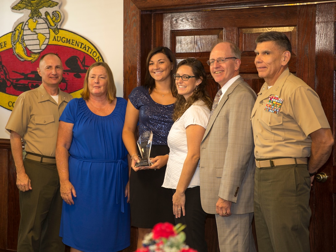 Representatives from the Environmental Restoration Program with Marine Corps Base Camp Lejeune’s Environmental Management Division were presented with the Secretary of the Navy Environmental Award aboard the base at the Officer’s Club, Aug. 8. Donald R. Schregardus, the deputy assistant secretary of the Navy (Environment), presented the award to team along with Maj. Gen. Juan Ayala, the Marine Corps Installations Command commanding general, and Col. James W. Clark, the deputy commander of Marine Corps Installations East. The Environmental Restoration Program was also recognized as the best program of its type throughout military and defense communities with a Secretary of Defense Environmental Award earlier this year. The program addresses ordnance and environmental concerns throughout the base. Since its inception in 1983, the Environmental Restoration team has performed environmental responses at more than 900 locations and is currently active in more than 80 sites. Charity Delaney, a native of Johnstown, Pennsylvania and the Installation Restoration Program manager, Jenni Reed, a native of Swansboro, North Carolina and the Fuel Tank Program manager and Patti Vanture a native of Virginia Beach, Virginia and an environmental engineer represented the team at the award presentation. 