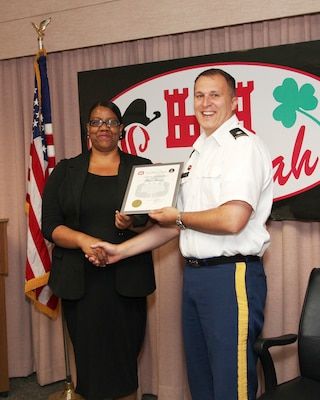 Lt. Col. Tom Woodie, Savannah District deputy commander, presents Paula Hanna, Family Readiness Network coordinator, a certificate of achievement in May for her accomplishments as the district's principal support liaison for deployed members and their families. 