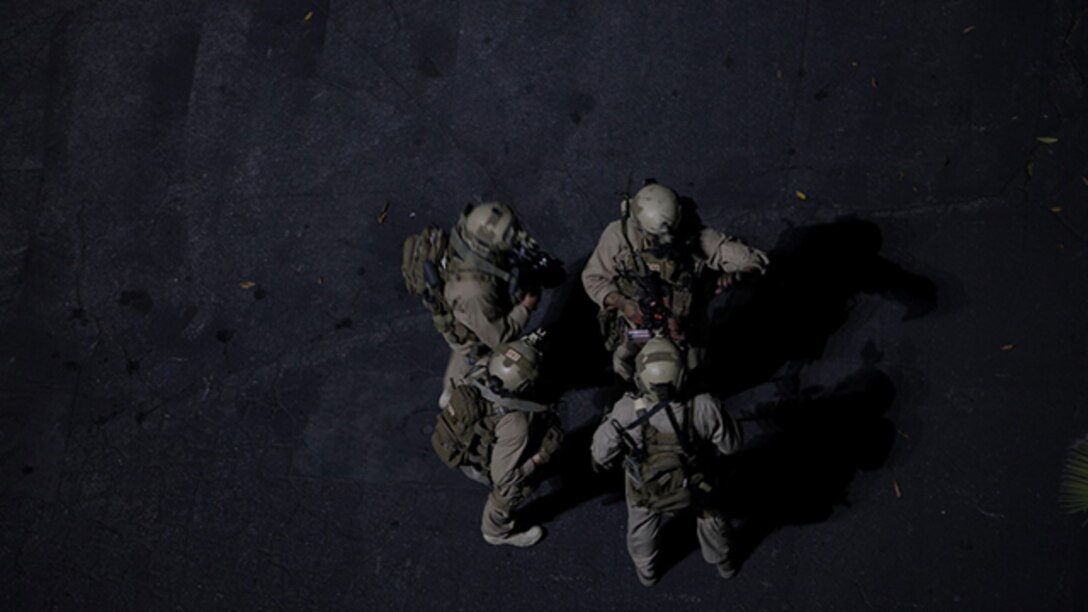U.S. Marines with the 15th Marine Expeditionary Unit’s Maritime Raid Force discuss the next stage in a raid at Dodger Stadium during realistic urban training in Los Angeles Dec. 8, 2014. RUT prepares the 15th MEU Marines for their upcoming deployment, enhancing their combat skills in environments similar to those they may find in future missions. (U.S. Marine Corps photo by Staff Sgt. Miguel Carrasco/Released)