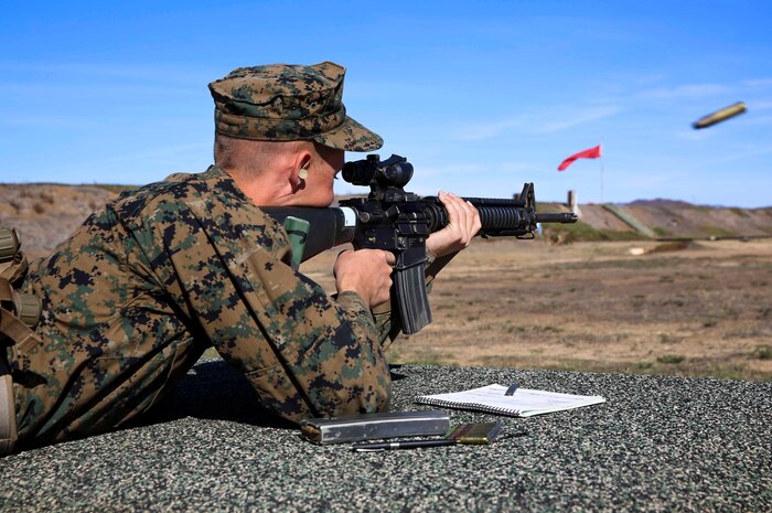 Recruit Daniel K. Schwedhelm, Kilo Company, 3rd Recruit Training Battalion, aim in at the target in the prone position from the 500-yard line at Edson Range, Weapons and Field Training Battalion, Marine Corps Base Camp Pendleton, Calif., Nov. 24. During Firing Week, recruits apply the basic fundamental marksmanship principles they learned to qualify with their weapon and be able to move forward with training. 